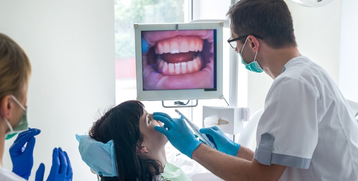 To what degree does Medicaid provide adult dental coverage?